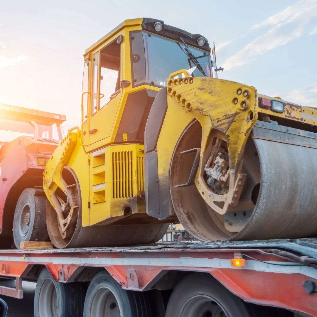 construction vehicle being hauled on a trailer